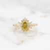 yellow-gold-oval-engagement-ring-with-marquise-and-round-diamond-halo-and-yellow-moissanite-engagement-ring