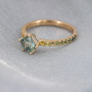 Alexis, with a teal Montana Sapphire  and ombre side stones