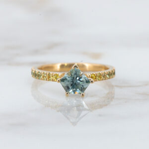 Alexis, with a teal Montana Sapphire  and ombre side stones